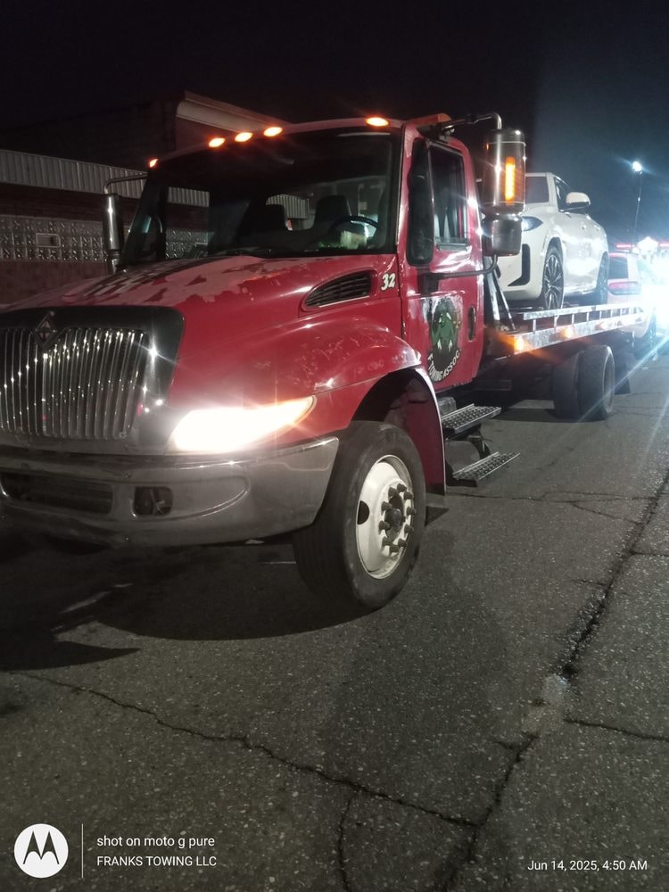 Frank's red flatbed tow truck